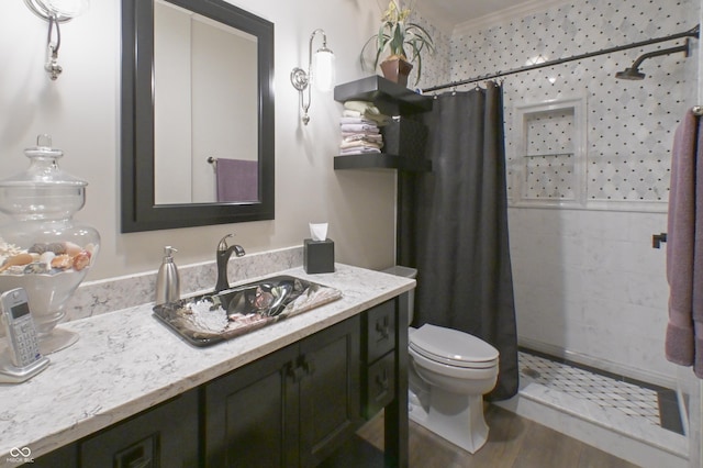 1614 Rosebud Ln Unit 83, Greenwood, IN 46143 - bathroom featuring tiled shower, toilet, vanity, ornamental molding, and wood finished floors