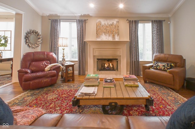 1614 Rosebud Ln Unit 83, Greenwood, IN 46143 - living room featuring wood finished floors, ornamental molding, healthy amount of natural light, and a lit fireplace