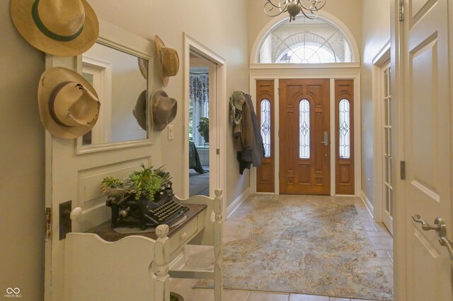1614 Rosebud Ln Unit 83, Greenwood, IN 46143 - foyer entrance featuring plenty of natural light, tile patterned flooring, and a chandelier
