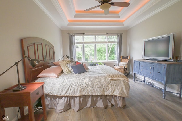 1614 Rosebud Ln Unit 83, Greenwood, IN 46143 - bedroom with wood finished floors, crown molding, a tray ceiling, and a ceiling fan