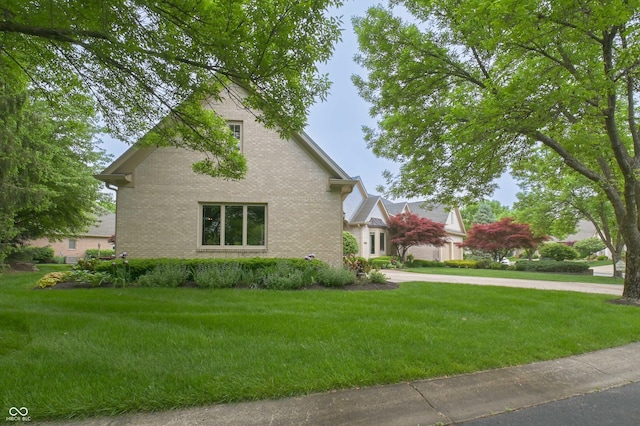 1614 Rosebud Ln Unit 83, Greenwood, IN 46143 - view of side of home featuring brick siding and a lawn