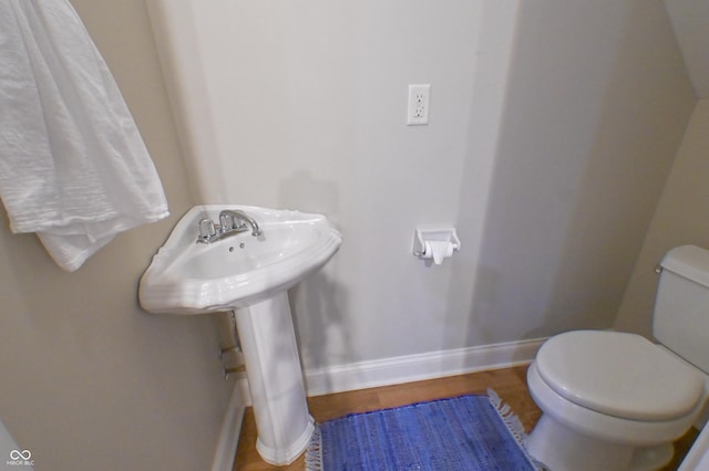 1614 Rosebud Ln Unit 83, Greenwood, IN 46143 - bathroom featuring baseboards, toilet, and wood finished floors