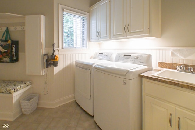 1614 Rosebud Ln Unit 83, Greenwood, IN 46143 - laundry area featuring washer and clothes dryer, cabinet space, wainscoting, and a decorative wall
