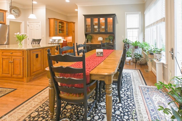1614 Rosebud Ln Unit 83, Greenwood, IN 46143 - dining space with light wood-type flooring, recessed lighting, and crown molding