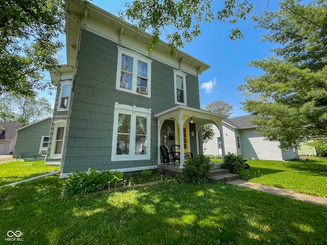 italianate-style house with a porch, a front yard, and cooling unit