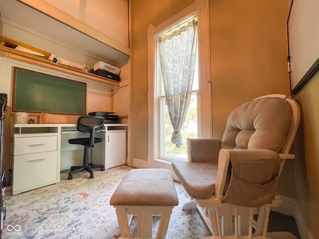 home office featuring built in study area and light carpet