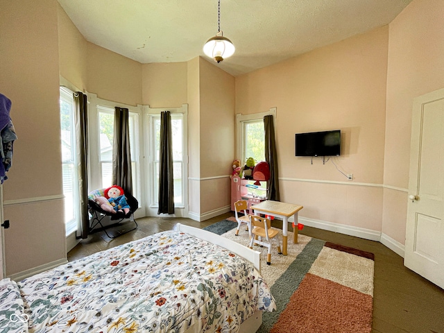 bedroom with multiple windows and baseboards