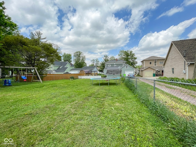 view of yard with a trampoline, a playground, and a residential view