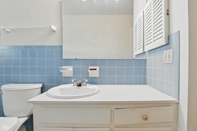 5038 Allisonville Rd Unit E, Indianapolis, IN 46205 - bathroom with vanity, toilet, and tile walls