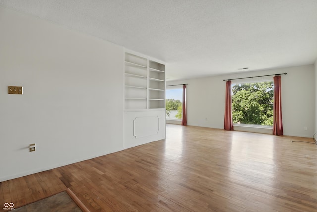 5038 Allisonville Rd Unit E, Indianapolis, IN 46205 - empty room with wood finished floors and a textured ceiling