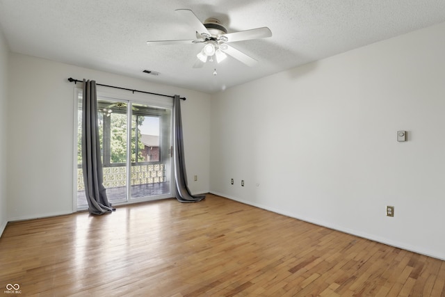 5038 Allisonville Rd Unit E, Indianapolis, IN 46205 - empty room with light wood-style flooring, ceiling fan, a textured ceiling, and baseboards