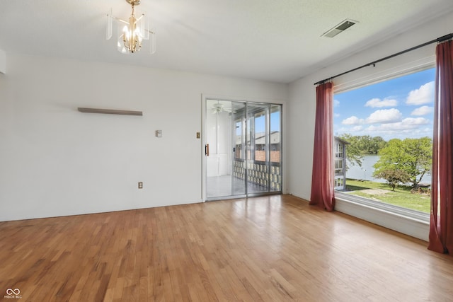 5038 Allisonville Rd Unit E, Indianapolis, IN 46205 - spare room featuring light wood-style floors and a chandelier