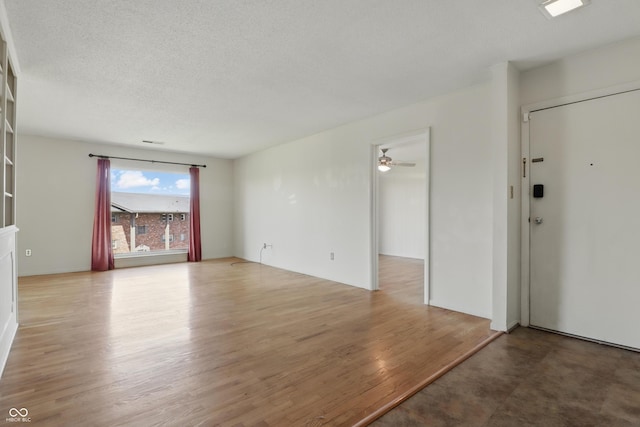5038 Allisonville Rd Unit E, Indianapolis, IN 46205 - unfurnished living room featuring light wood-type flooring, a ceiling fan, and a textured ceiling