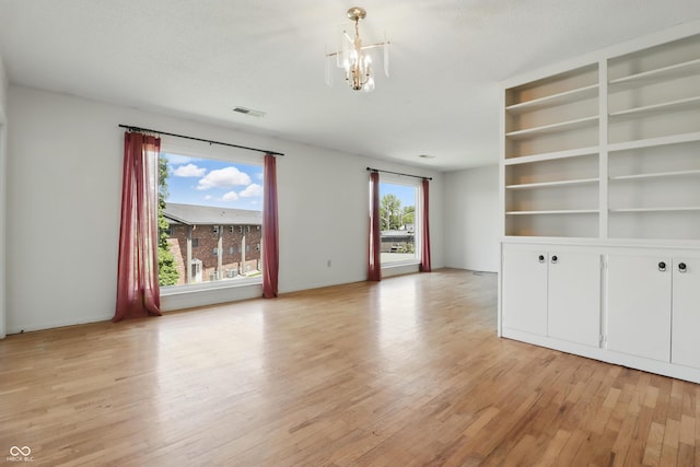 5038 Allisonville Rd Unit E, Indianapolis, IN 46205 - spare room with light wood-type flooring and a chandelier