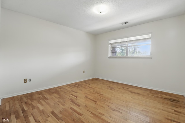 5038 Allisonville Rd Unit E, Indianapolis, IN 46205 - spare room with light wood-type flooring, baseboards, and a textured ceiling