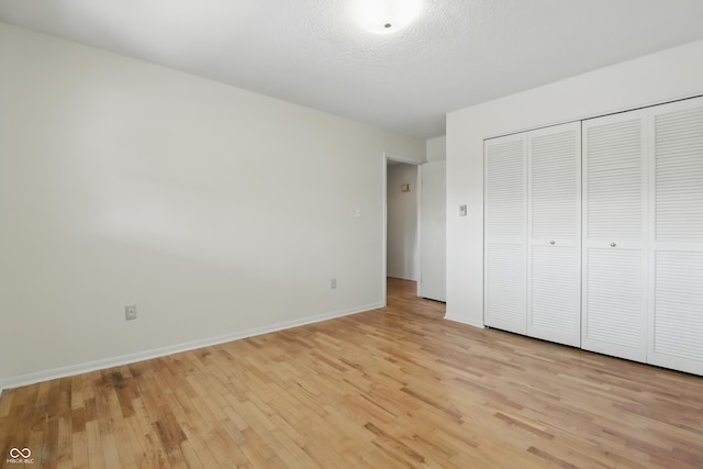 5038 Allisonville Rd Unit E, Indianapolis, IN 46205 - unfurnished bedroom with light wood-style floors, baseboards, and a closet