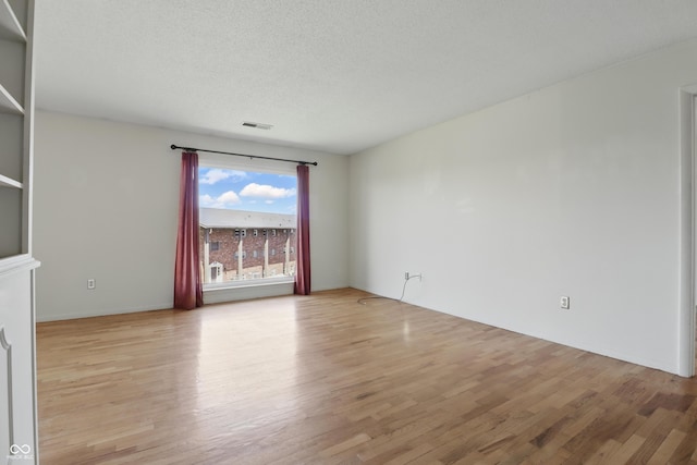 5038 Allisonville Rd Unit E, Indianapolis, IN 46205 - empty room with light wood-style flooring and a textured ceiling