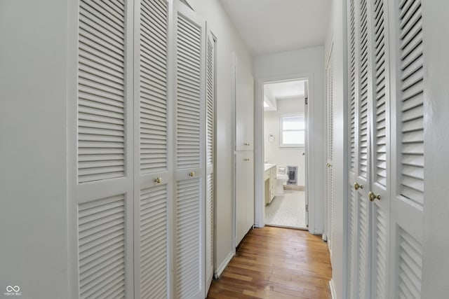 5038 Allisonville Rd Unit E, Indianapolis, IN 46205 - hallway with light wood-type flooring and baseboards
