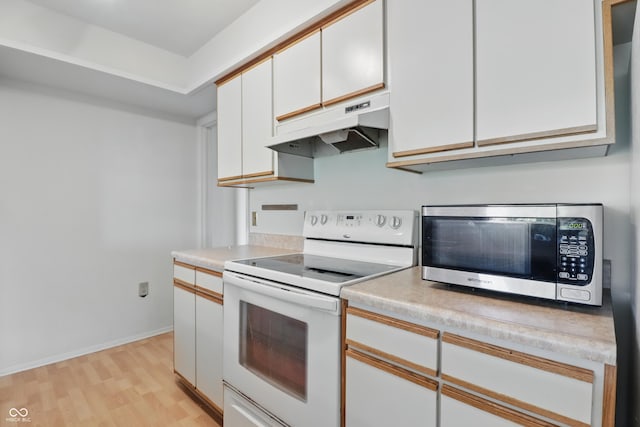 5038 Allisonville Rd Unit E, Indianapolis, IN 46205 - kitchen featuring white electric stove, under cabinet range hood, stainless steel microwave, white cabinets, and light wood-style flooring