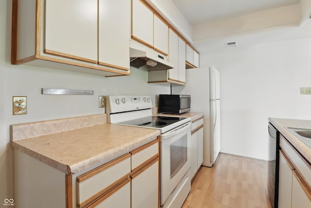 5038 Allisonville Rd Unit E, Indianapolis, IN 46205 - kitchen with stainless steel appliances, under cabinet range hood, light wood-style floors, light countertops, and white cabinetry