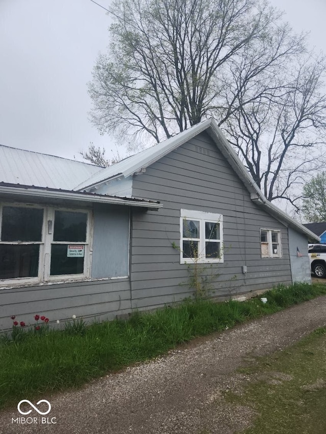 view of side of home with metal roof