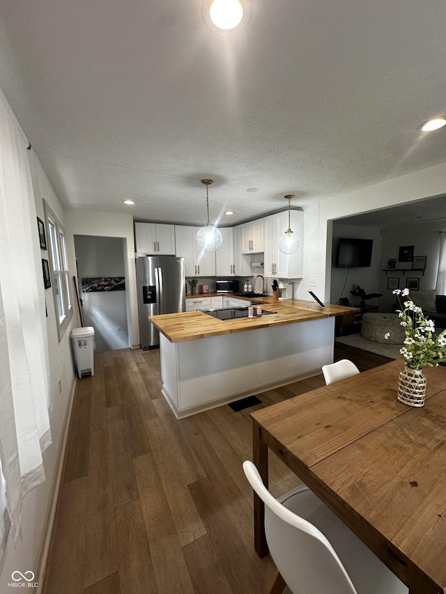 426 St Paul St, Indianapolis, IN 46201 - kitchen featuring butcher block counters, stainless steel fridge with ice dispenser, black microwave, a peninsula, and a sink