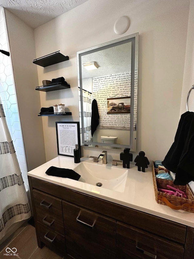 426 St Paul St, Indianapolis, IN 46201 - full bathroom featuring toilet, vanity, curtained shower, and a textured ceiling