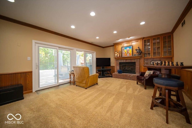 11536 Woods Bay Ln, Indianapolis, IN 46236 - living area with crown molding, light carpet, recessed lighting, wainscoting, and a brick fireplace