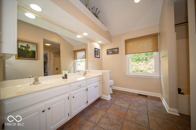 11536 Woods Bay Ln, Indianapolis, IN 46236 - bathroom with vaulted ceiling, toilet, double vanity, plenty of natural light, and baseboards