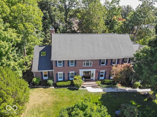 11536 Woods Bay Ln, Indianapolis, IN 46236 - view of front facade featuring a chimney, a front yard, and brick siding