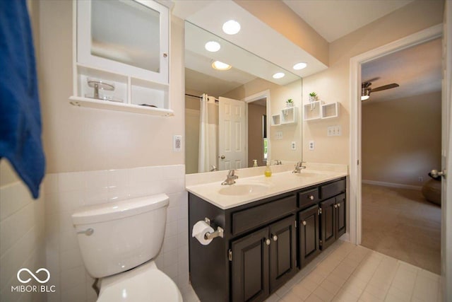 11536 Woods Bay Ln, Indianapolis, IN 46236 - full bath featuring toilet, double vanity, tile walls, tile patterned floors, and recessed lighting