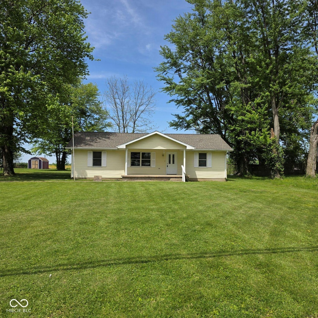 3816 W State Road 340, Brazil, IN 47834 - view of front facade featuring a porch, a front yard, a storage shed, an outdoor structure, and roof with shingles