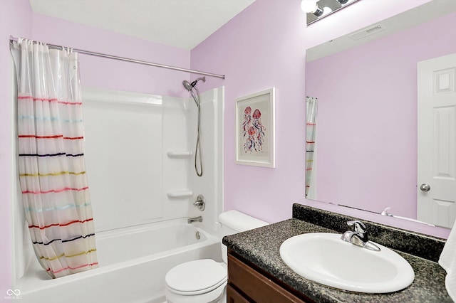 bathroom with shower / bathtub combination with curtain, toilet, and vanity