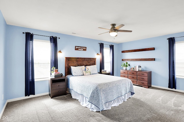 carpeted bedroom featuring baseboards and ceiling fan