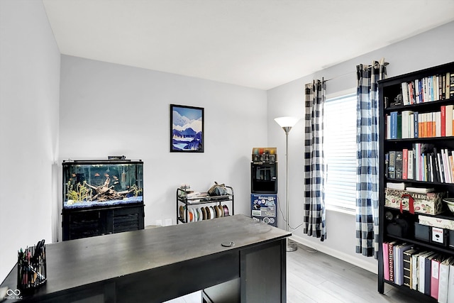 office area with light wood-style flooring and baseboards