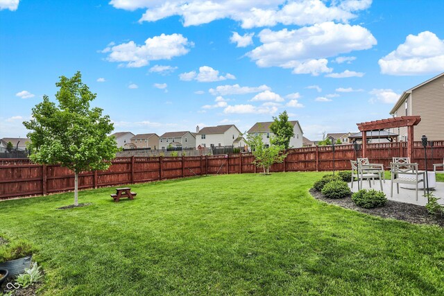 view of yard with a residential view, a pergola, and a patio area