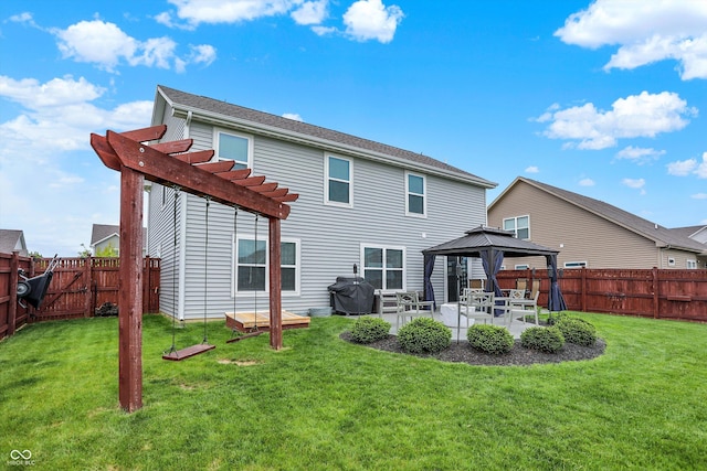 rear view of property featuring a gazebo, a pergola, and a patio area