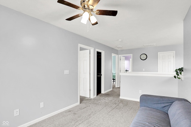 living room featuring baseboards, carpet floors, and ceiling fan