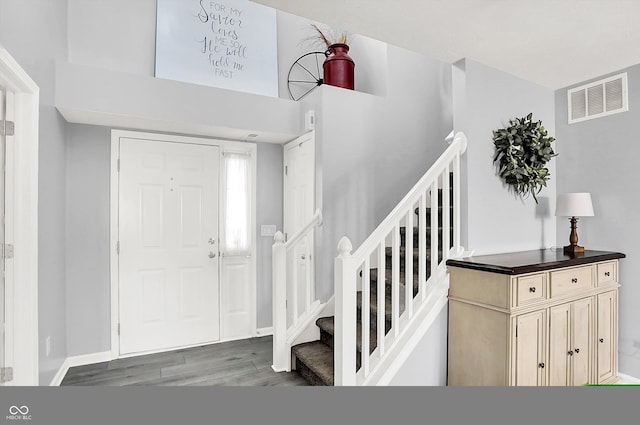 entrance foyer featuring stairs, wood finished floors, and baseboards