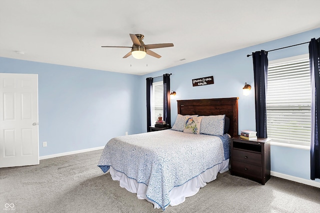 carpeted bedroom with baseboards and ceiling fan