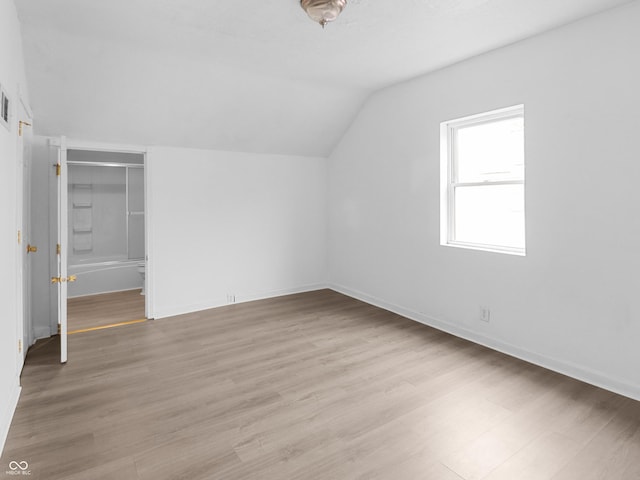 1225 S Monroe St, Muncie, IN 47302 - additional living space featuring lofted ceiling, light wood-style flooring, and baseboards