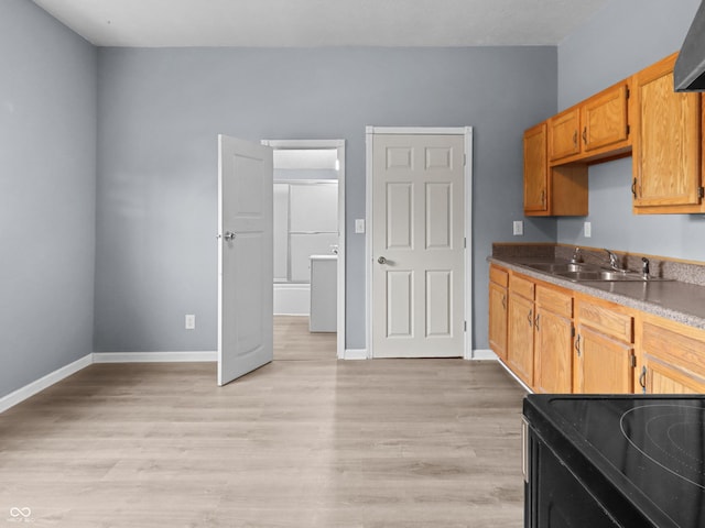 1225 S Monroe St, Muncie, IN 47302 - kitchen with a sink, light wood-style flooring, baseboards, and black range with electric cooktop