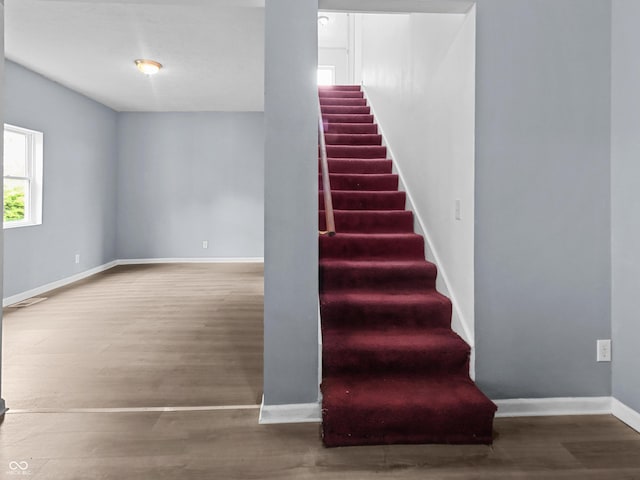 1225 S Monroe St, Muncie, IN 47302 - staircase with wood finished floors and baseboards