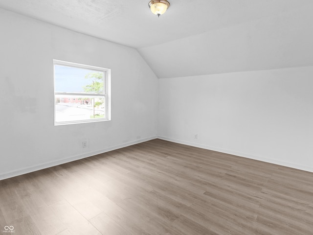 1225 S Monroe St, Muncie, IN 47302 - additional living space with vaulted ceiling, wood finished floors, and baseboards