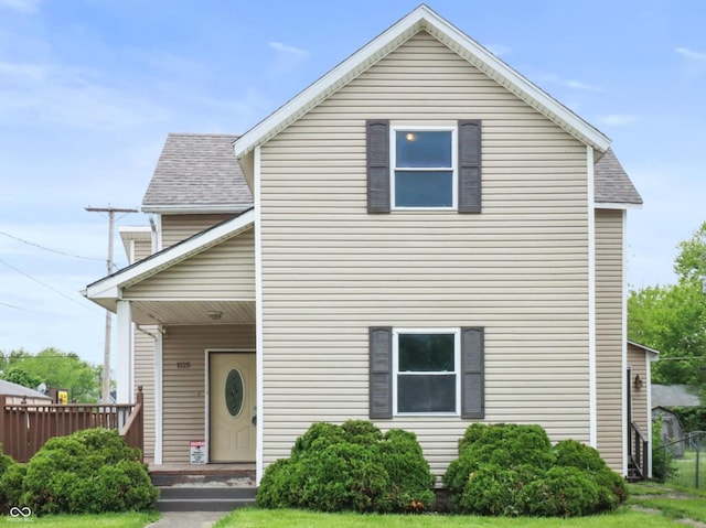 1225 S Monroe St, Muncie, IN 47302 - traditional home with roof with shingles, covered porch, and a front yard