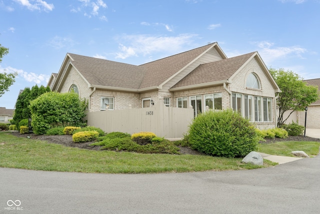 11438 Winding Wood Dr, Indianapolis, IN 46235 - view of side of home with a shingled roof and brick siding