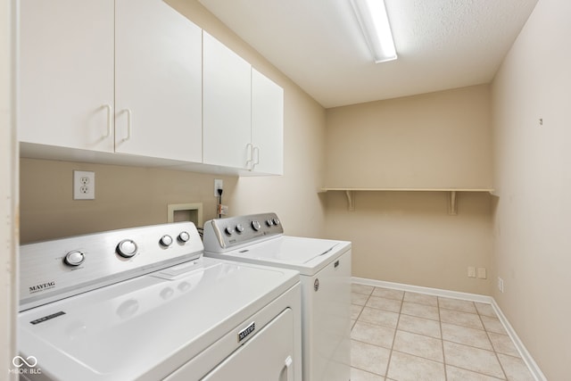 11438 Winding Wood Dr, Indianapolis, IN 46235 - washroom with cabinet space, washing machine and dryer, light tile patterned floors, and baseboards