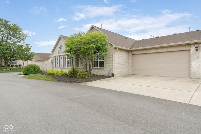 11438 Winding Wood Dr, Indianapolis, IN 46235 - ranch-style home featuring brick siding, a garage, driveway, and roof with shingles