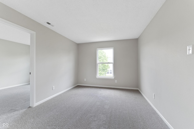 carpeted empty room with baseboards