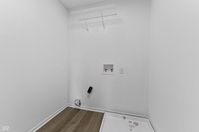 laundry room with dark wood finished floors, baseboards, and hookup for a washing machine